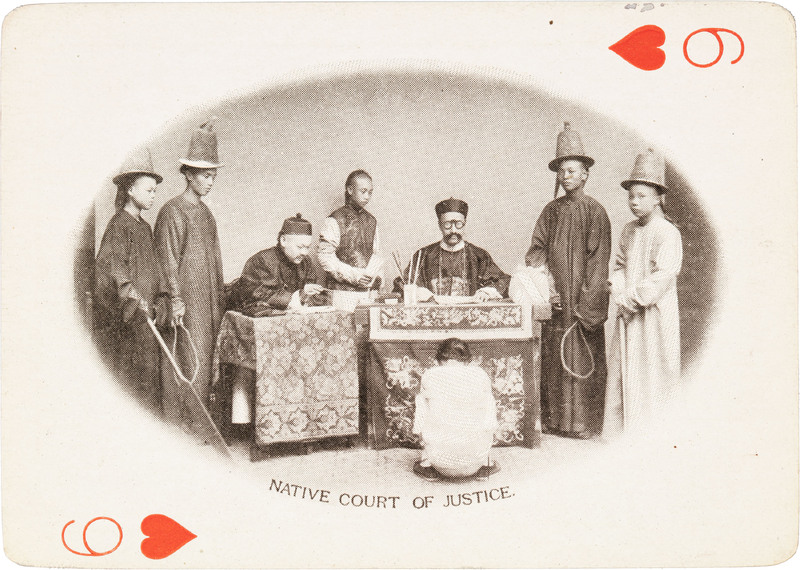 The 6 of hearts with a group of men standing around another sitting on the ground