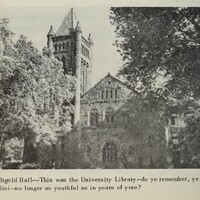 Building with tower behind some trees.
