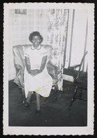 Black and white photograph of Gwendolyn Brooks sitting in a chair with a sheer cover.